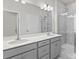 Beautiful bathroom featuring double vanity with quartz countertops and tiled shower at 5024 Colline Ct, Charlotte, NC 28216