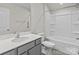Standard bathroom with gray vanity and a bathtub with shower head at 5024 Colline Ct, Charlotte, NC 28216