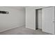 Neutral bedroom offers carpeted floor and an open closet with sliding doors at 5024 Colline Ct, Charlotte, NC 28216