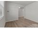 Versatile empty room with wood floors, offering endless possibilities for customization and use, bright and airy at 5024 Colline Ct, Charlotte, NC 28216