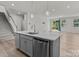 Kitchen island featuring stainless steel appliances and easy access to the living area, complemented by wood floors at 5024 Colline Ct, Charlotte, NC 28216