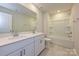 Bright bathroom featuring a double sink vanity with modern fixtures, a large mirror, and a shower-tub combo at 5025 Poplin Vly, Cherryville, NC 28021