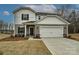 Charming two-story home featuring a neutral color scheme, a two-car garage, and a well-manicured front lawn at 5025 Poplin Vly, Cherryville, NC 28021