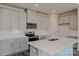 Well-lit kitchen boasts a center island, stainless steel appliances, stylish cabinetry, and tile backsplash at 5027 Poplin Vly, Cherryville, NC 28021