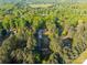 Aerial view of home surrounded by lush, mature trees, showing its location in a serene environment at 5039 Pine Springs Dr, Bessemer City, NC 28016