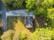 Aerial view of the home showcasing its location, gravel driveway, and surrounding greenery at 5039 Pine Springs Dr, Bessemer City, NC 28016