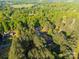 Aerial view of property, displaying the house nestled among mature trees and lush greenery at 5039 Pine Springs Dr, Bessemer City, NC 28016