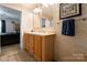 Bathroom featuring a double sink vanity with wood cabinets and neutral decor at 5039 Pine Springs Dr, Bessemer City, NC 28016