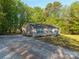 A lovely single-story home featuring vinyl siding and a long, gravel driveway at 5039 Pine Springs Dr, Bessemer City, NC 28016