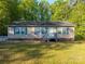 Charming single-story home with a well-maintained lawn and inviting front porch at 5039 Pine Springs Dr, Bessemer City, NC 28016
