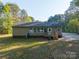 Back of the house with a cozy deck, stairs, and large windows overlooking a spacious lawn at 5039 Pine Springs Dr, Bessemer City, NC 28016