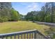 A lovely view of the expansive yard and surrounding trees from the home's porch at 5039 Pine Springs Dr, Bessemer City, NC 28016