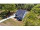 Aerial view of a gray home featuring a long driveway, lush green lawns, and surrounding trees at 515 Edmunds Ln # 38, Clover, SC 29710