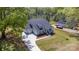 Aerial view of a gray home with a three-car garage, lush landscaping, and a long driveway at 515 Edmunds Ln # 38, Clover, SC 29710