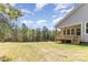 Expansive backyard and wooden porch with stairs on a well-maintained gray home at 515 Edmunds Ln # 38, Clover, SC 29710