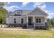 Inviting home featuring a covered porch with stone accents and manicured lawn at 515 Edmunds Ln # 38, Clover, SC 29710