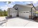 Spacious three-car garage with white doors and stone accents on a gray home exterior at 515 Edmunds Ln # 38, Clover, SC 29710