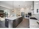 Bright kitchen with large island, modern pendant lighting, stainless steel appliances, and a view to the fireplace at 515 Edmunds Ln # 38, Clover, SC 29710