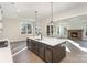 Open kitchen with island, stainless appliances, and connecting living space with fireplace at 515 Edmunds Ln # 38, Clover, SC 29710