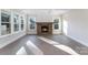 Bright living room with a stone fireplace, hardwood floors, and large windows at 515 Edmunds Ln # 38, Clover, SC 29710