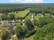 Scenic aerial view showcases a rural property with verdant pastures and mature trees, creating a serene country setting at 5159 Taxahaw Rd, Lancaster, SC 29720