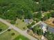 Aerial view of the property, displaying the home and the surrounding area with lush greenery and nearby houses at 5159 Taxahaw Rd, Lancaster, SC 29720