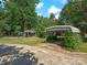 Expansive backyard with detached carport, a shed, mature trees, and a partial fence at 5159 Taxahaw Rd, Lancaster, SC 29720