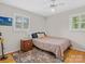 Cozy bedroom with hardwood floors, a ceiling fan, window with blinds, and a nightstand with drawers at 5159 Taxahaw Rd, Lancaster, SC 29720