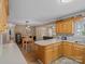 Charming eat-in kitchen featuring wood cabinets, dining area, and connecting living space at 5159 Taxahaw Rd, Lancaster, SC 29720