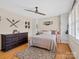Comfortable main bedroom featuring hardwood floors, ceiling fan, a neutral color palette and ample closet space at 5159 Taxahaw Rd, Lancaster, SC 29720