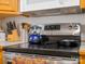 Stainless steel stove with a blue tea kettle sitting atop the glass stovetop at 5159 Taxahaw Rd, Lancaster, SC 29720