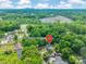 Aerial view of property at 5227 Pinebrook Drive surrounded by mature trees, neighborhood, and skyline in the distance at 5227 Pinebrook Dr, Charlotte, NC 28208