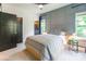 Stylish bedroom featuring a gray accent wall, carpet and modern fixtures at 5227 Pinebrook Dr, Charlotte, NC 28208
