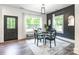 Elegant dining room features modern lighting, stylish furniture, and large windows offering serene outdoor views at 5227 Pinebrook Dr, Charlotte, NC 28208