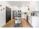 Contemporary kitchen featuring white cabinets, an island with barstool seating, and stainless steel appliances, perfect for cooking at 5227 Pinebrook Dr, Charlotte, NC 28208