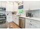Bright kitchen featuring white cabinets, stainless steel appliances, and a tiled backsplash at 5227 Pinebrook Dr, Charlotte, NC 28208