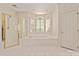 Bathroom featuring a shower, a soaking tub, and a large window with plantation shutters, plus patterned wallpaper at 5335 Lower Shoal Creek Ct, Charlotte, NC 28277