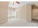 This bright carpeted bedroom offers a private bathroom, shuttered windows, and natural lighting at 5335 Lower Shoal Creek Ct, Charlotte, NC 28277