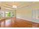 This spacious bedroom offers hardwood floors, recessed ceiling, lake views, and plantation shutters on the windows at 5335 Lower Shoal Creek Ct, Charlotte, NC 28277