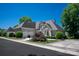 Stately home showcasing professional landscaping, a three-car garage, and a well-maintained lawn at 5335 Lower Shoal Creek Ct, Charlotte, NC 28277