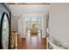 Grand foyer featuring hardwood floors, elegant columns, and a view of the bright and inviting living room at 5335 Lower Shoal Creek Ct, Charlotte, NC 28277