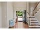 Inviting foyer showcasing hardwood floors, an elegant staircase, and a view to the front yard at 5335 Lower Shoal Creek Ct, Charlotte, NC 28277