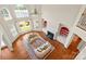 Bright and airy living room featuring two-story ceilings, lake views, hardwood floors, and a cozy fireplace at 5335 Lower Shoal Creek Ct, Charlotte, NC 28277