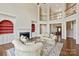 Grand living room with fireplace, built-ins, and view of the front entry at 5335 Lower Shoal Creek Ct, Charlotte, NC 28277