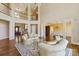 Bright living room boasts high ceilings, wood floors, and an upper level overlook at 5335 Lower Shoal Creek Ct, Charlotte, NC 28277