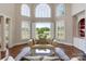 Inviting living room with ample light, large windows, and golf course views at 5335 Lower Shoal Creek Ct, Charlotte, NC 28277
