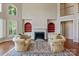 Spacious living room with a fireplace, built-in shelving, and large windows, offering great natural light at 5335 Lower Shoal Creek Ct, Charlotte, NC 28277