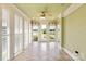 Light-filled sunroom with tile floor, ceiling fan and view of the backyard pond at 5335 Lower Shoal Creek Ct, Charlotte, NC 28277