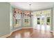 Bright sunroom features hardwood floors, light green walls, many windows, and access to the backyard and lake at 5335 Lower Shoal Creek Ct, Charlotte, NC 28277
