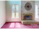 Close up of fireplace with decorative metal art and large windows for plenty of natural light at 611 Stowe Rd, Clover, SC 29710